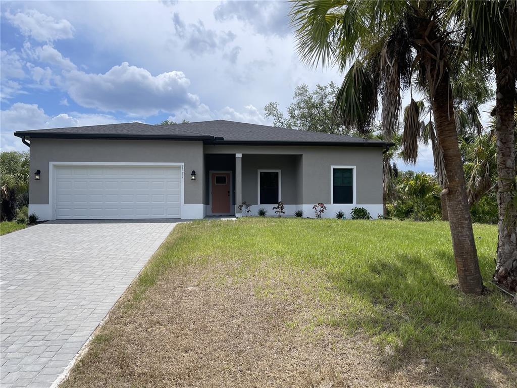 a front view of house with yard and trees