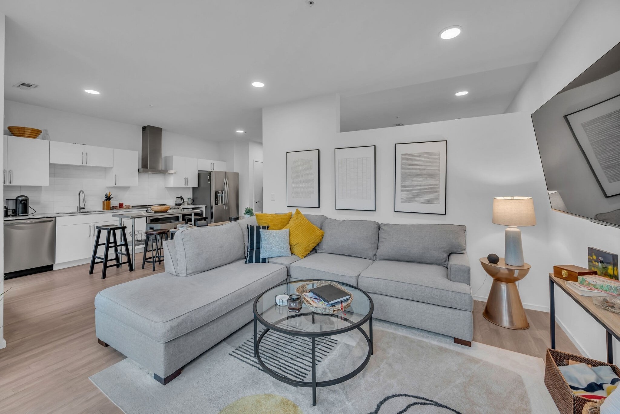 a living room with furniture and a wooden floor