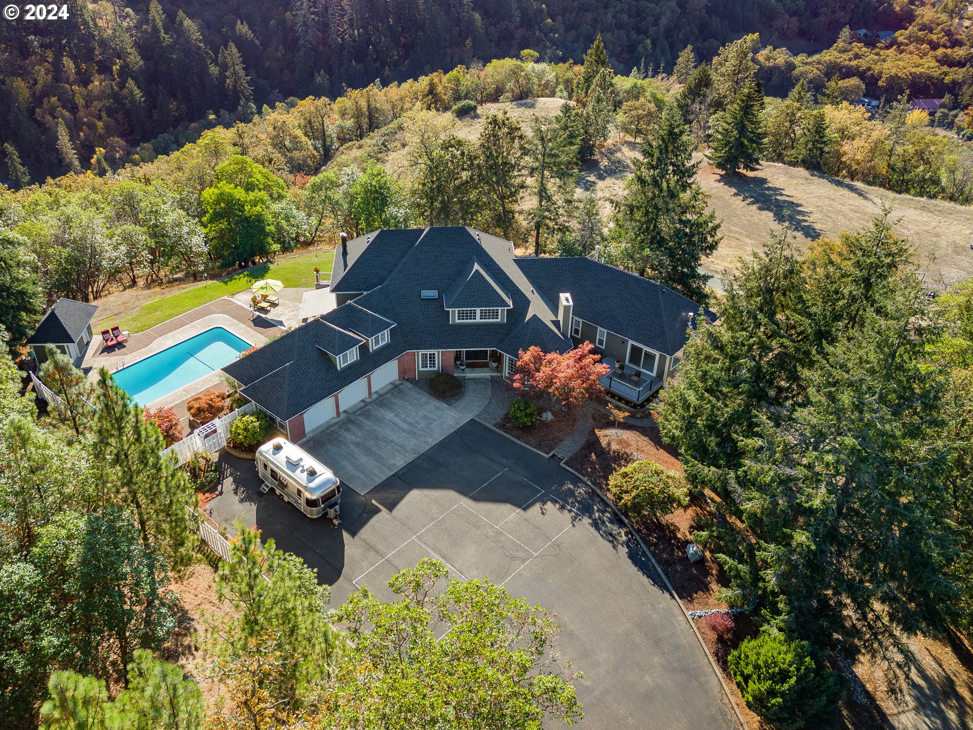 an aerial view of a house with a yard