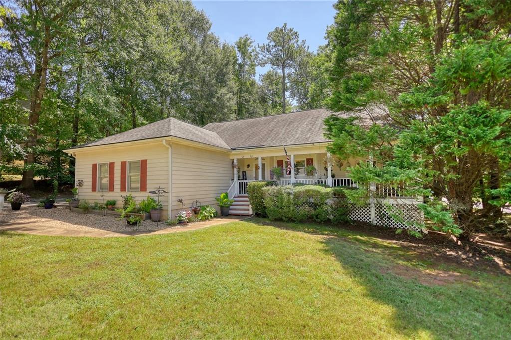 a view of a house with backyard and sitting area