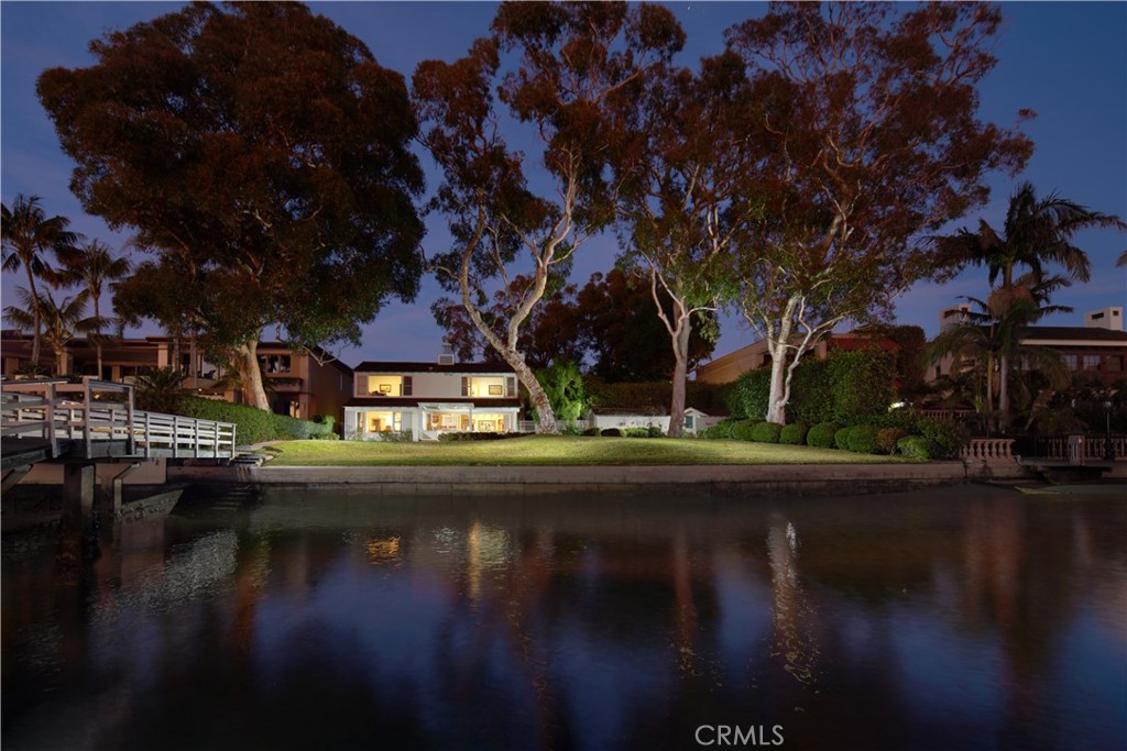 a view of swimming pool with outdoor seating and lake view