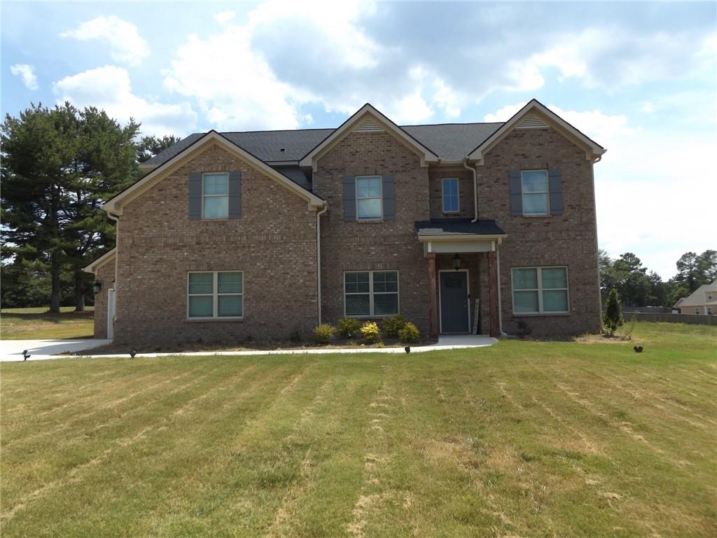 a front view of a house with a yard