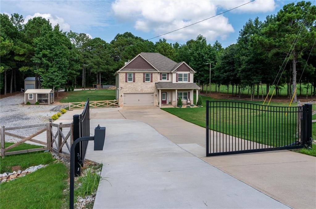 a view of a house with backyard and sitting area