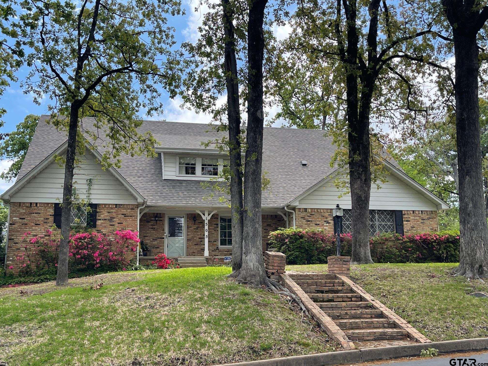 a front view of a house with garden