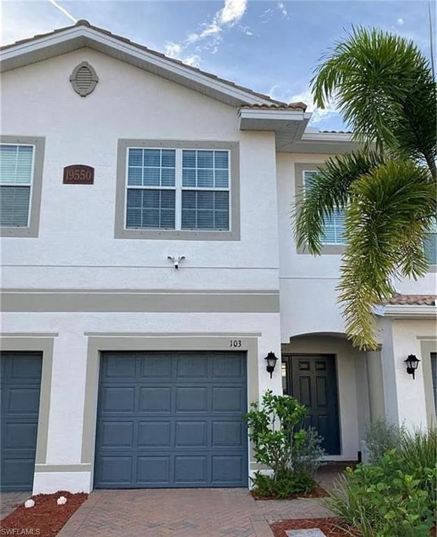 a front view of a house with a yard and garage