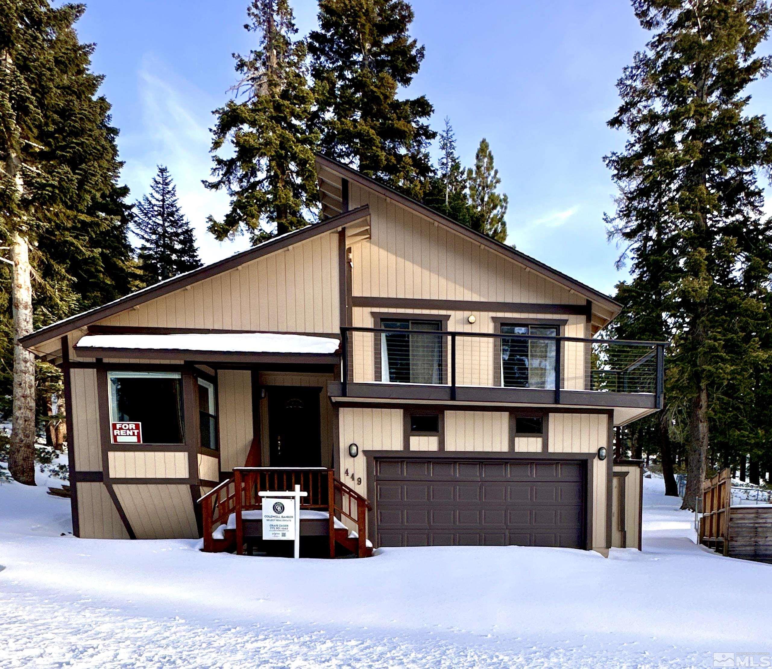 a front view of a house with large windows