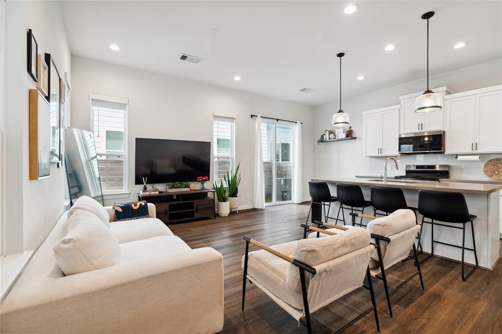 a living room with fireplace furniture and a flat screen tv