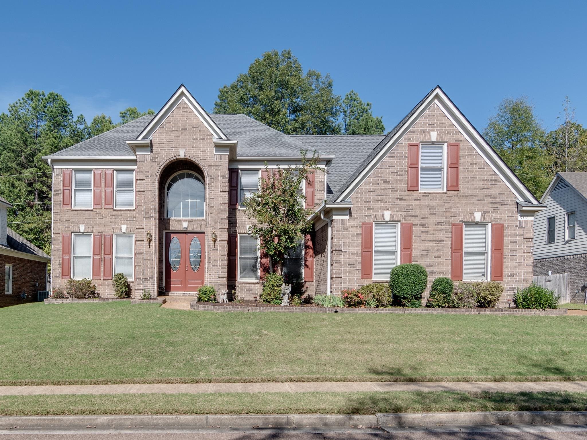 a front view of a house with a yard