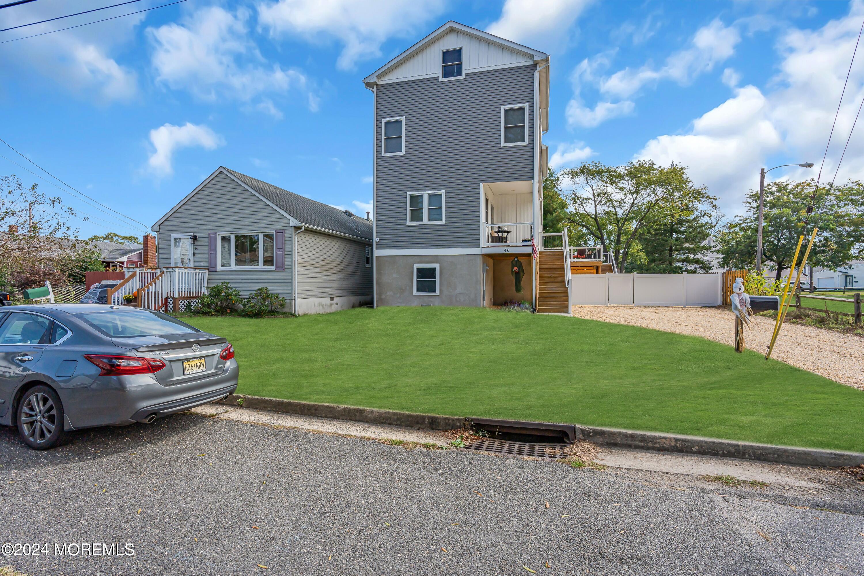 a car parked in front of a house with a yard