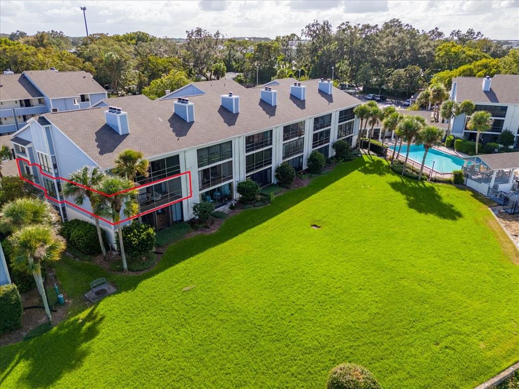 a view of a house with a big yard and large trees