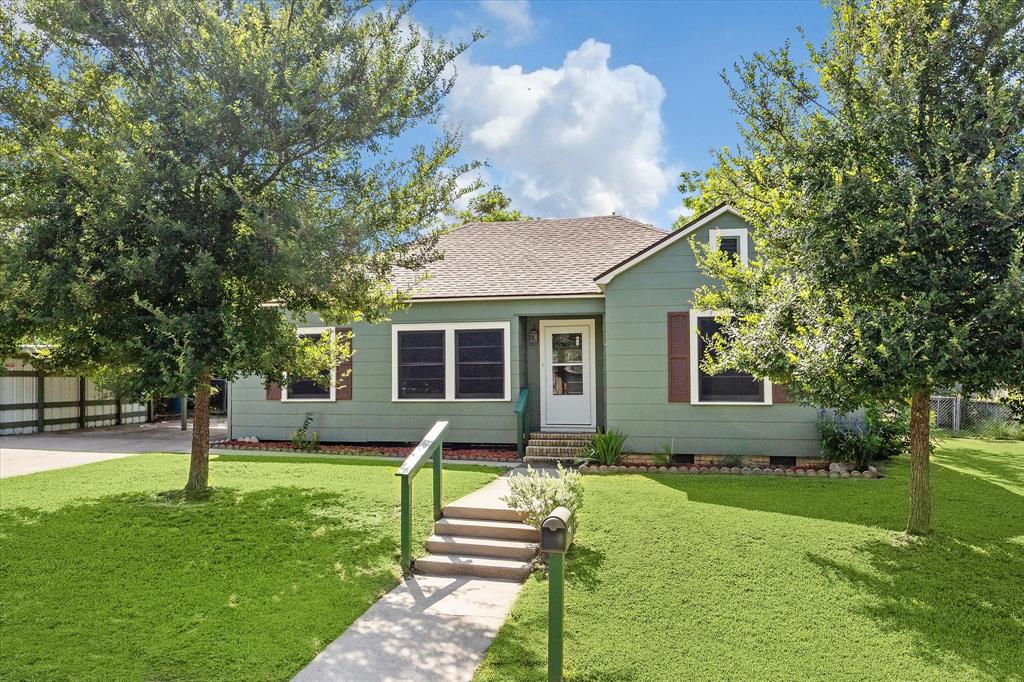 a front view of house with a garden and patio