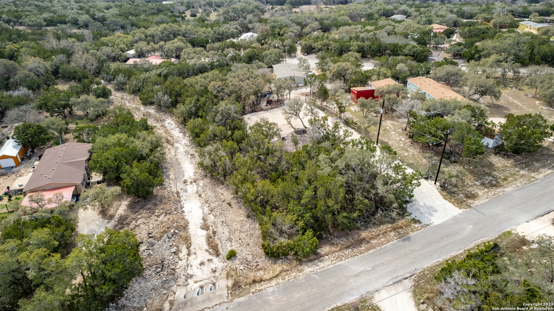 an aerial view of a house with a yard