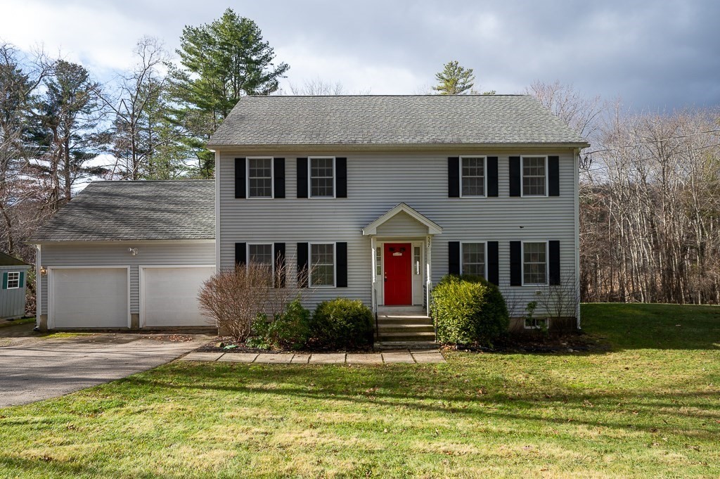 a front view of a house with a yard and garage