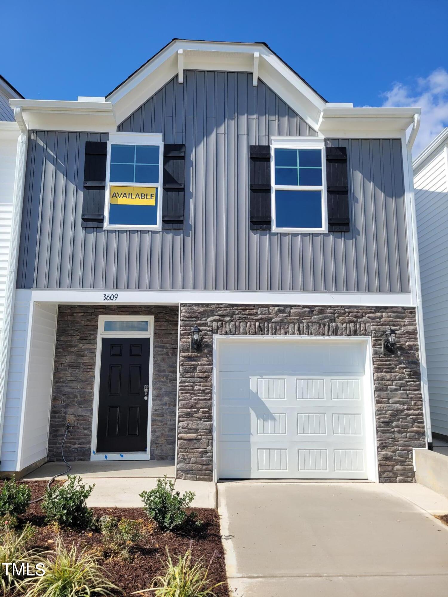 a front view of a house with a garage