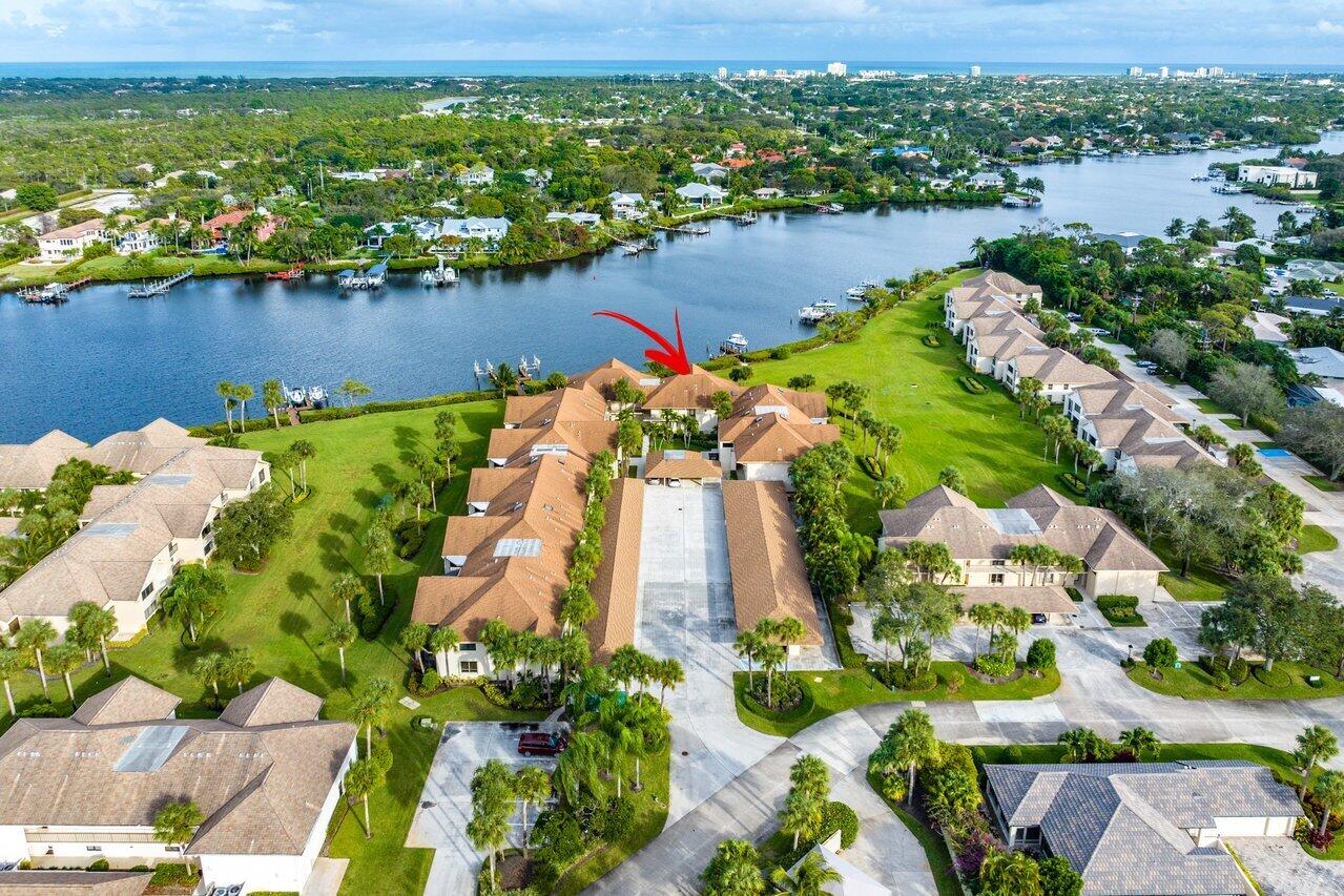 an aerial view of a house with a yard and lake view