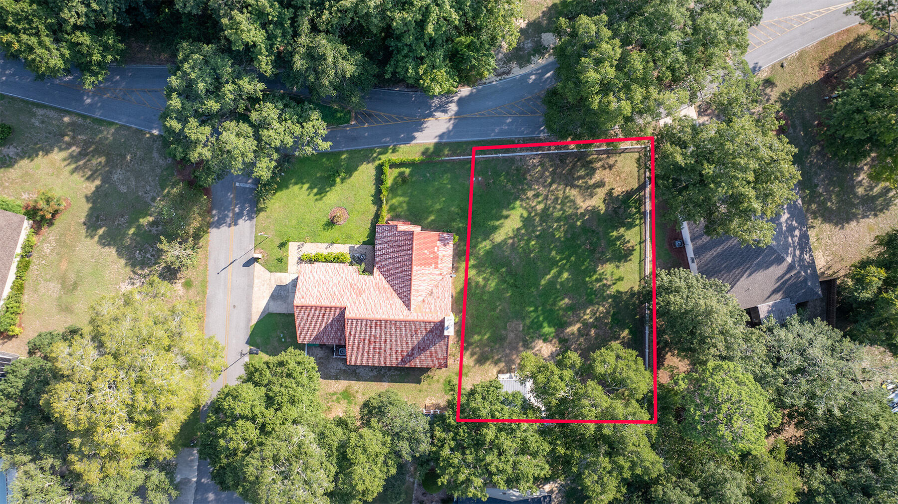 an aerial view of a house with a yard basket ball court and outdoor seating