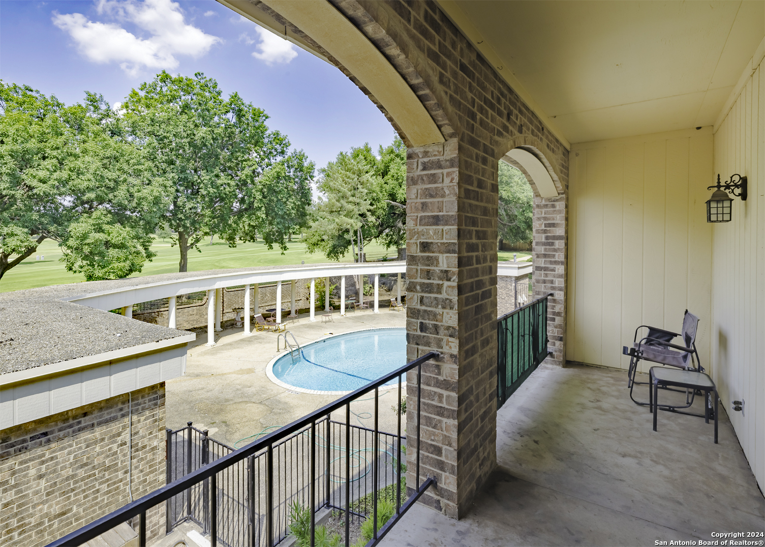 a view of a balcony with chairs