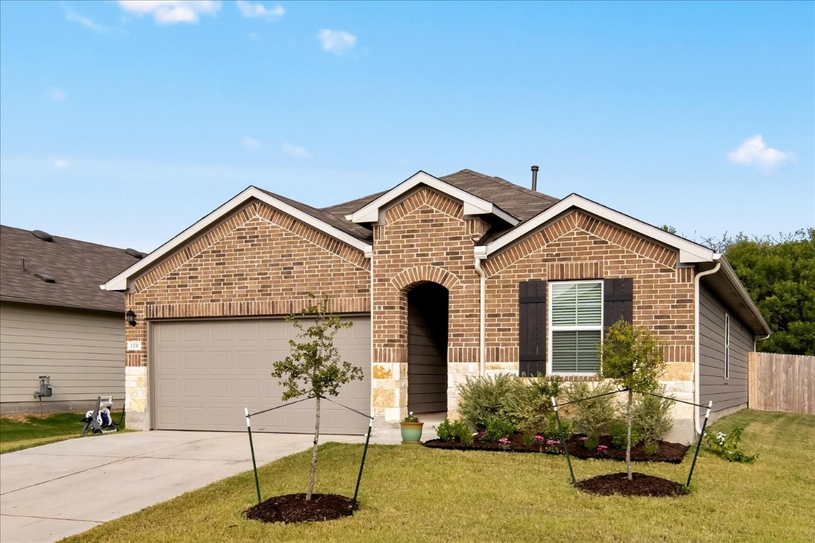 a front view of a house with garden