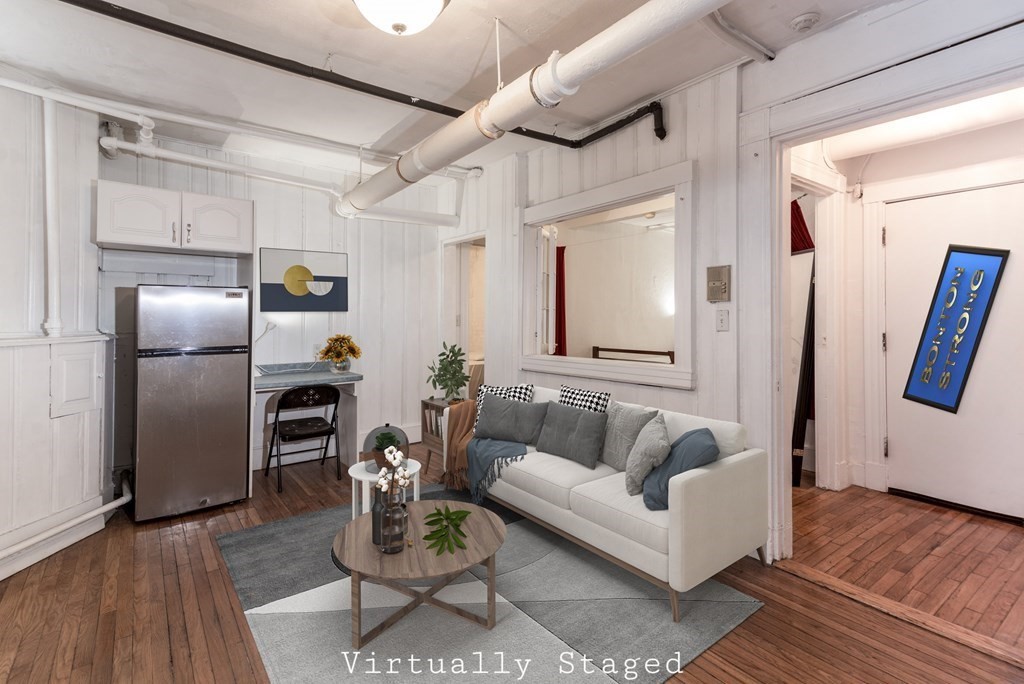 a living room with furniture or couch and a wooden floor