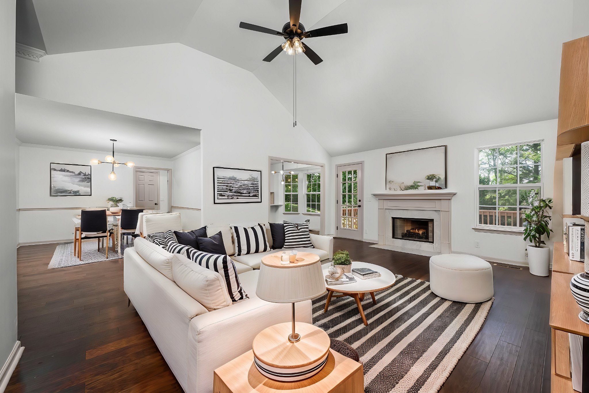 a living room with furniture a fireplace and a table