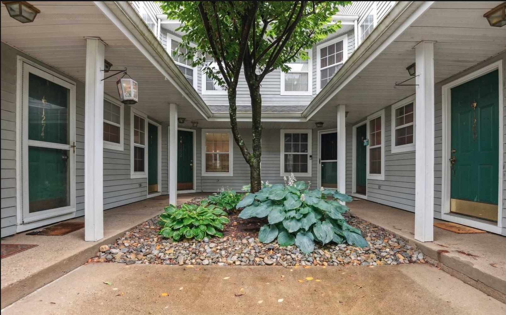 a front view of a house with garden