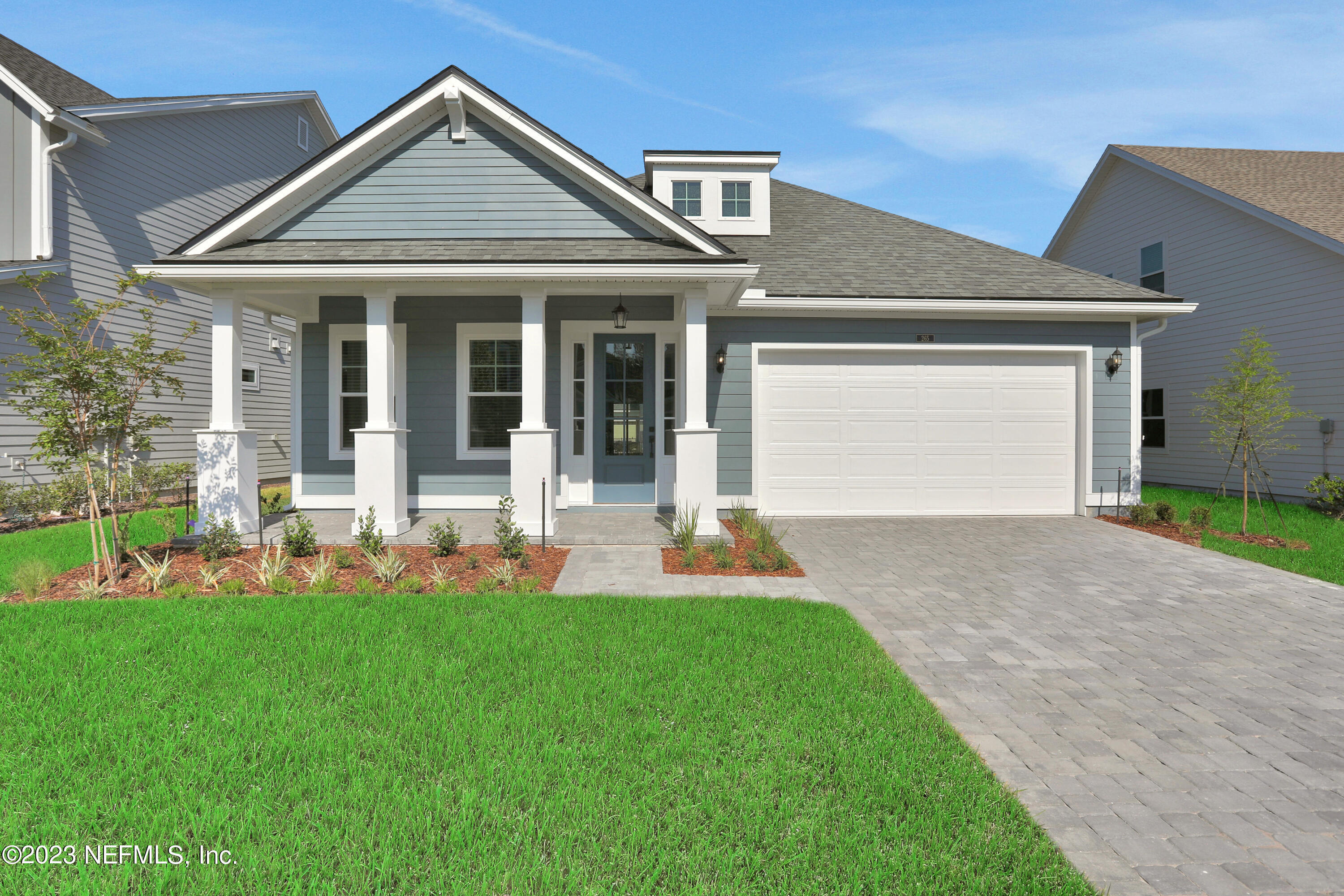 a front view of a house with a yard and porch