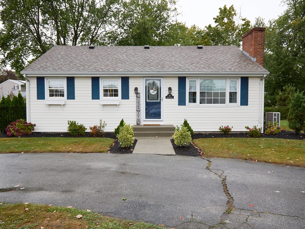 a front view of a house with a yard and a garage