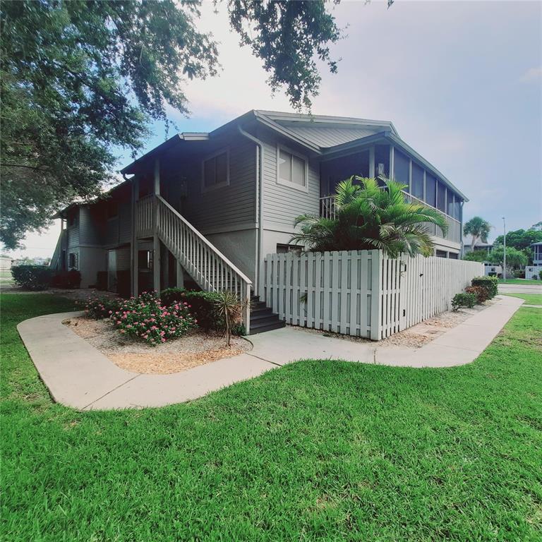 a view of a house with a yard and wooden fence