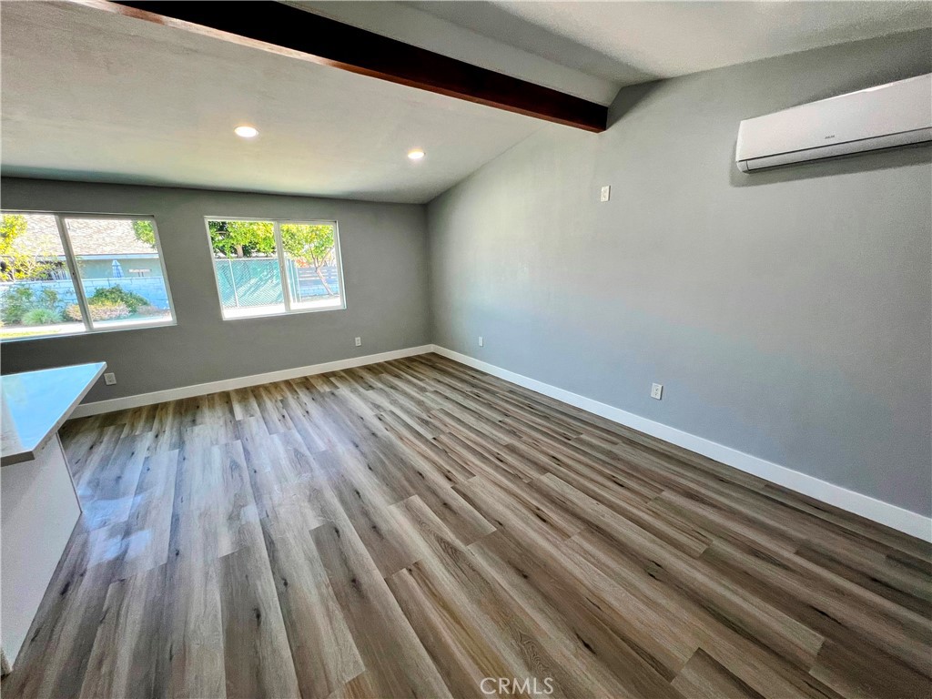 a view of room with window and wooden floor