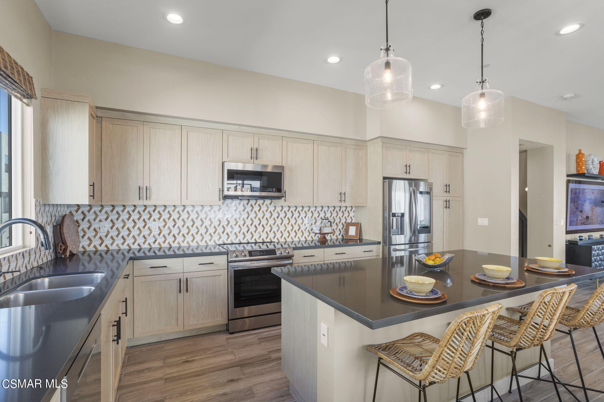 a kitchen with a sink a stove and chairs