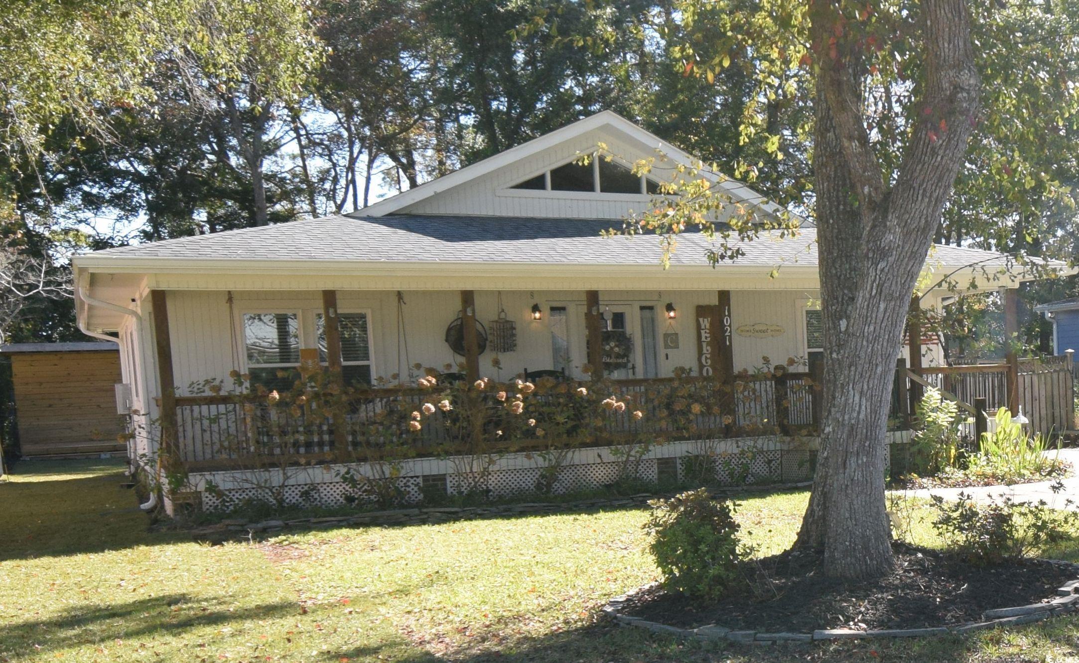 View of front of property with a front lawn and a