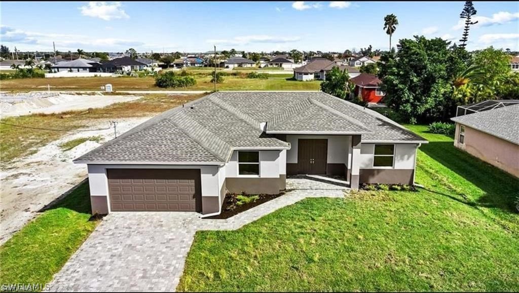 a aerial view of a house with swimming pool and large trees