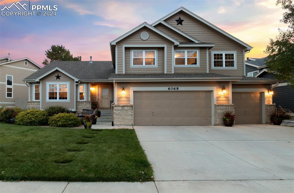 a front view of a house with a yard and garage