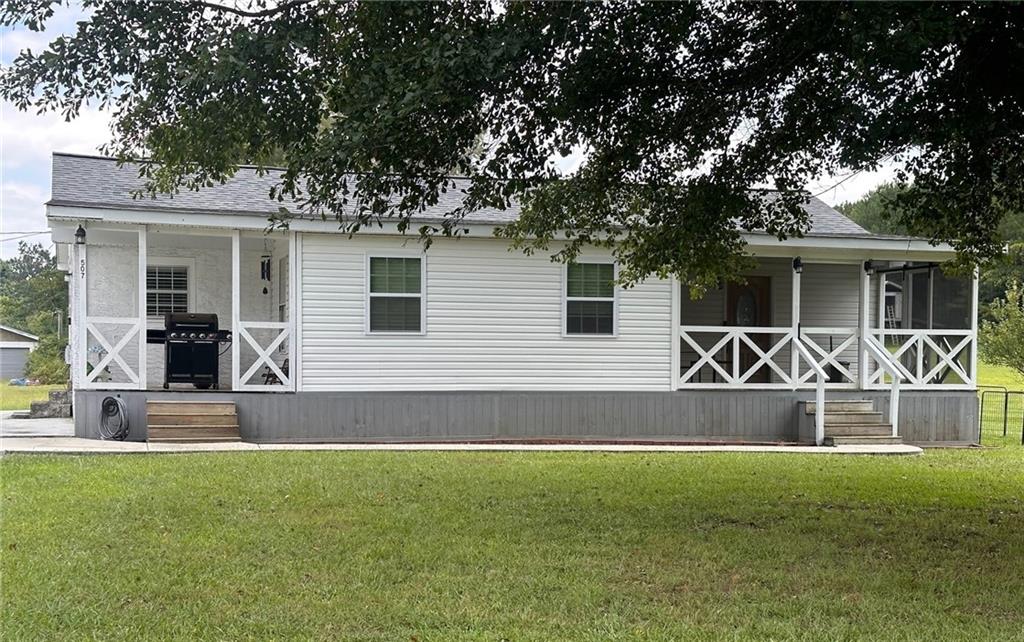 a front view of a house with yard and seating space