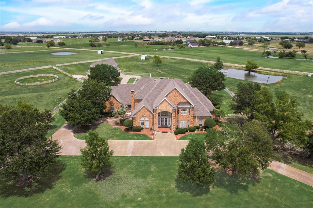 an aerial view of a house with a yard basket ball court and outdoor seating