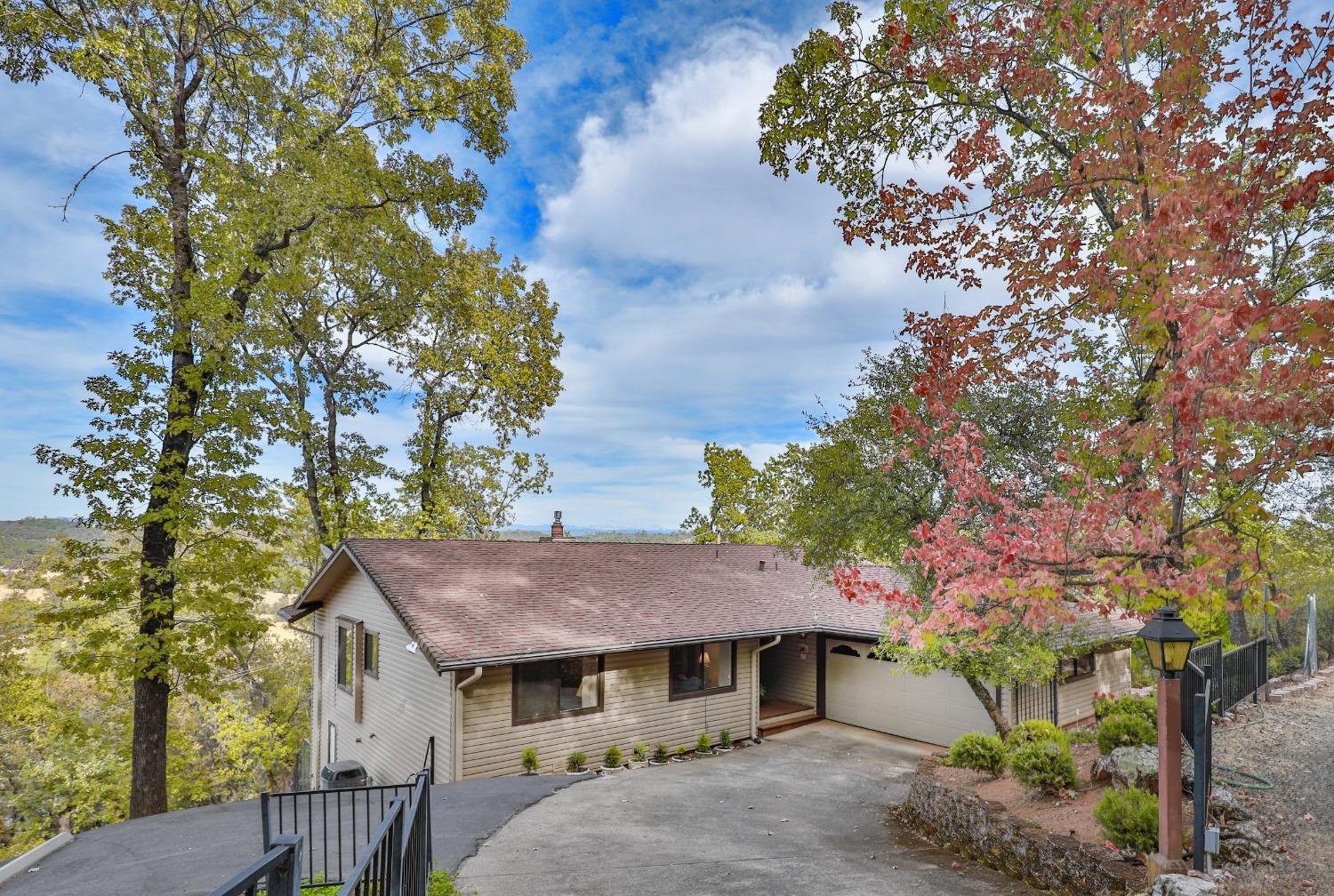 a view of a house with a tree in the background