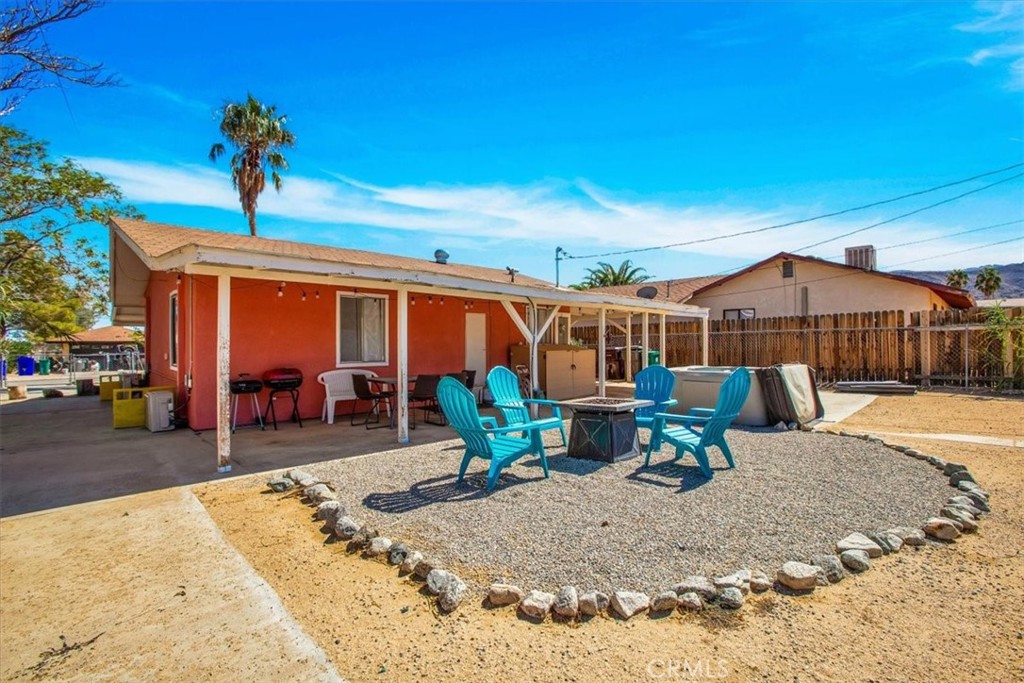 a view of a backyard with sitting area