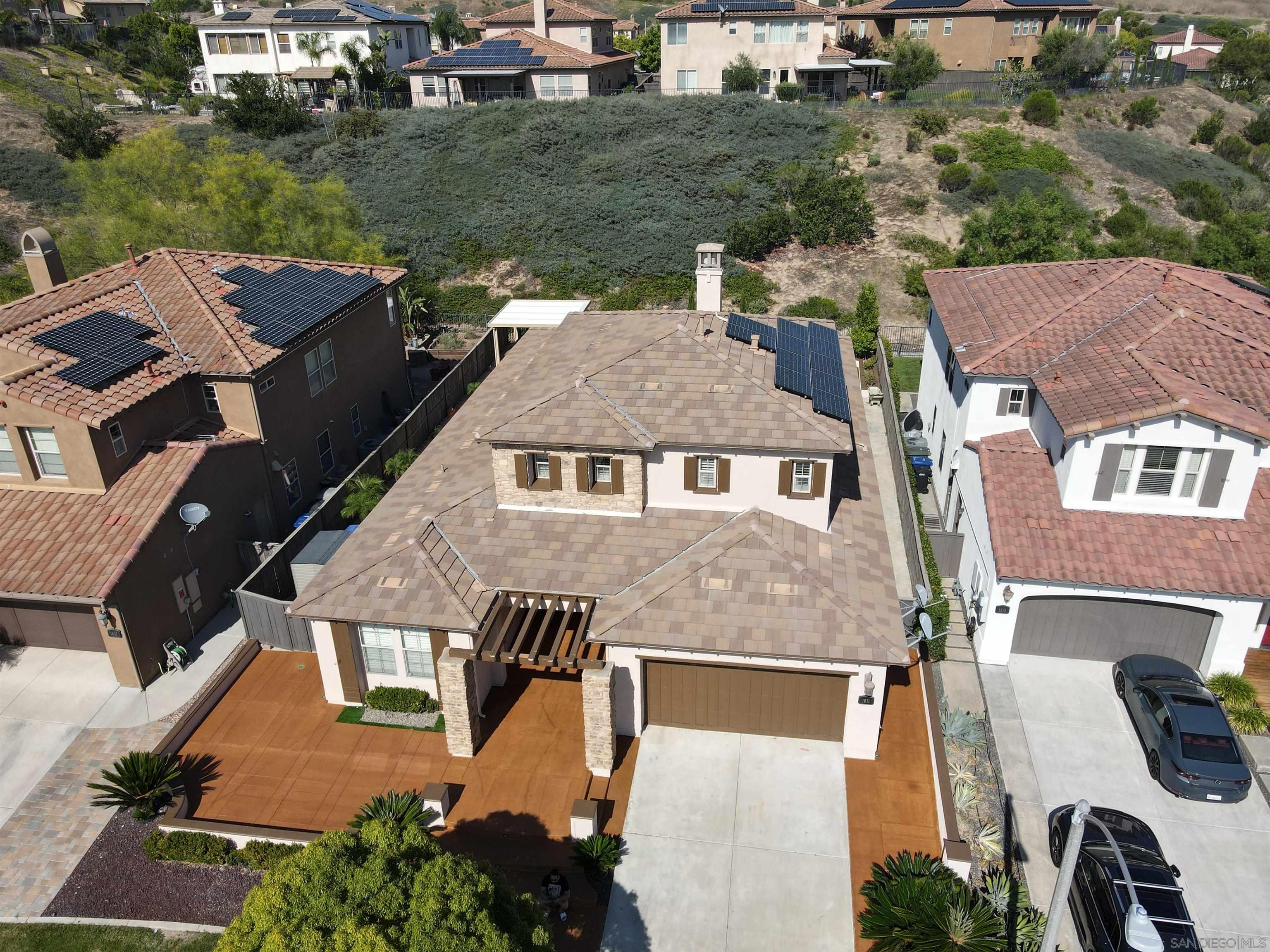 an aerial view of a house with a yard basket ball court and outdoor seating