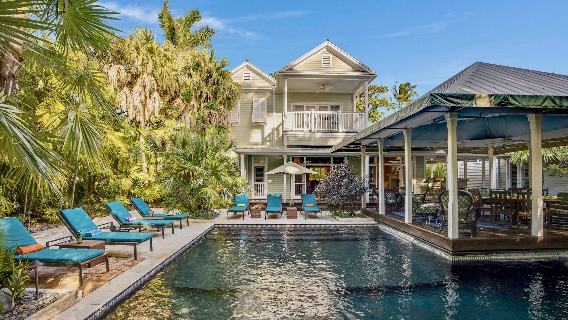 a view of a house with swimming pool and sitting area