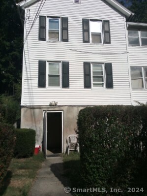 a front view of a house with plants