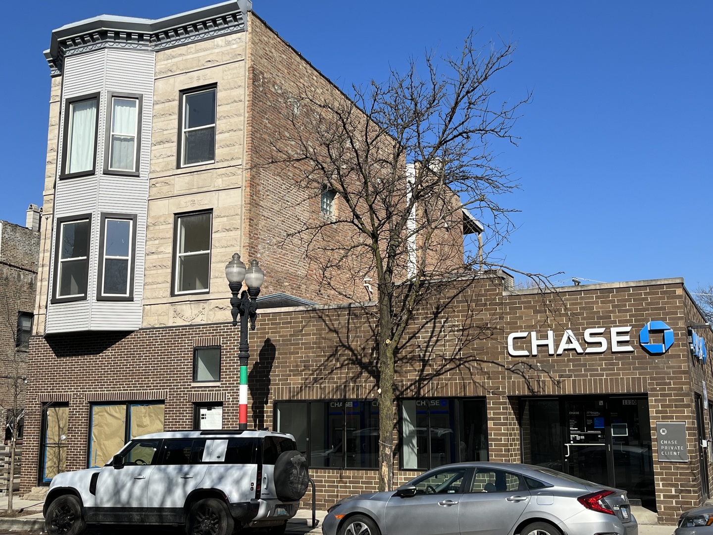 a view of a building with car parked