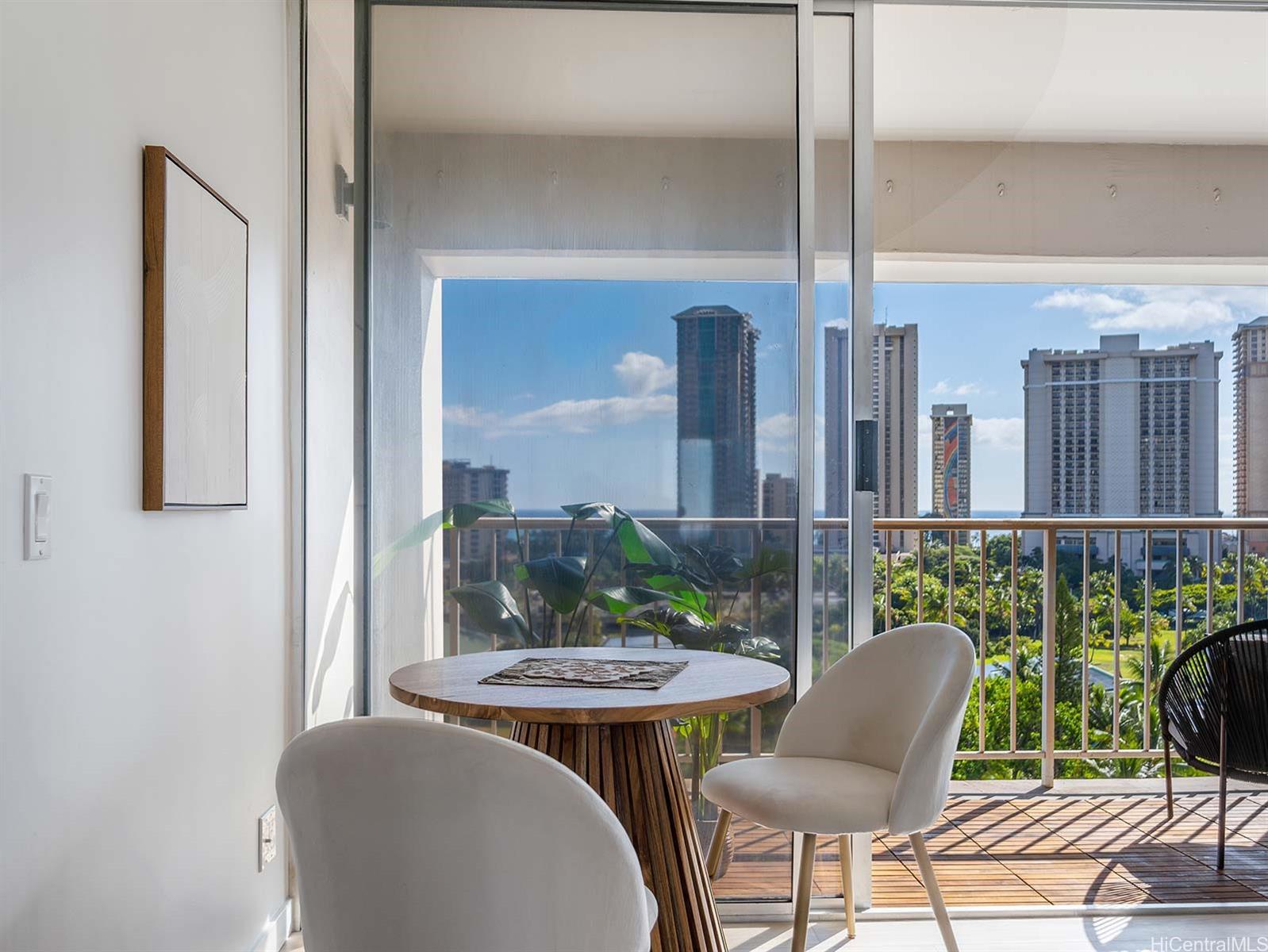 a view of a balcony with chairs and a table