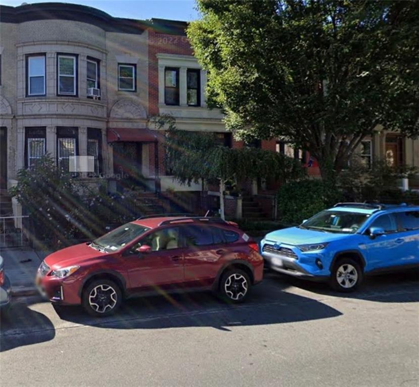 a view of a car parked in front of a house