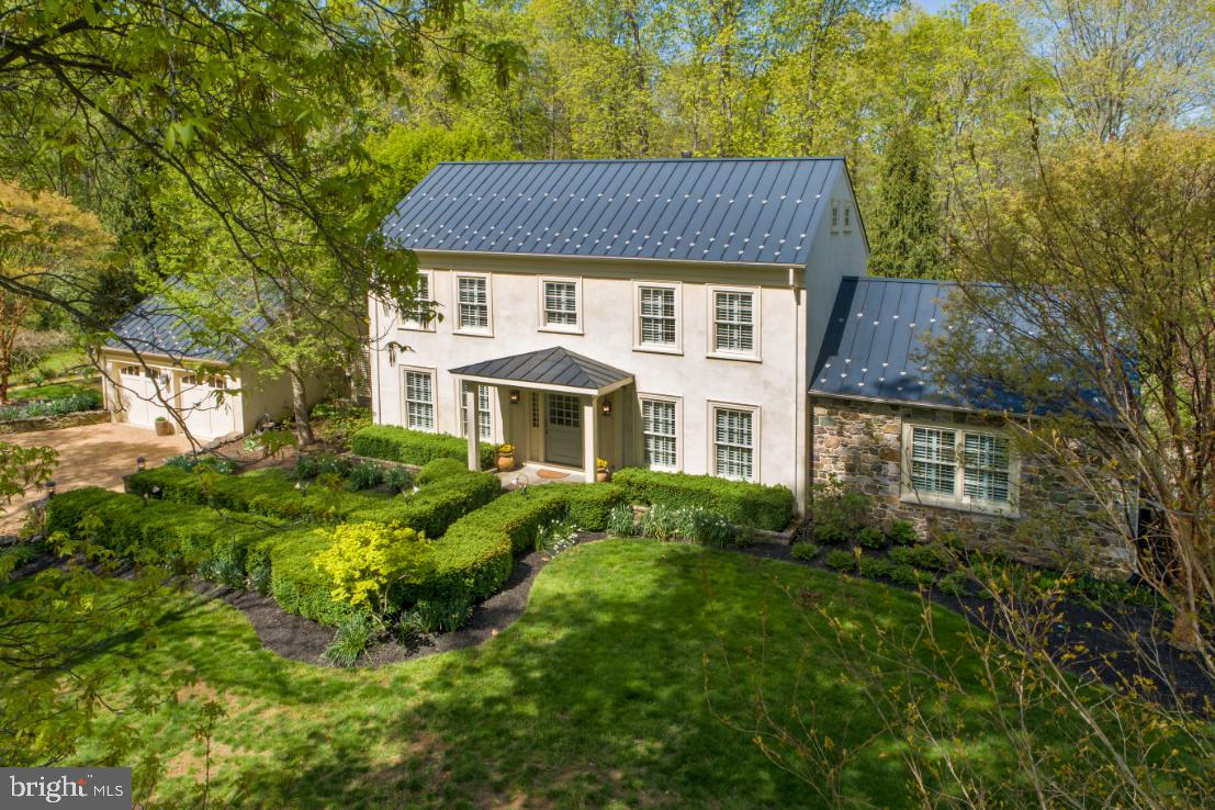 a aerial view of a house next to a yard