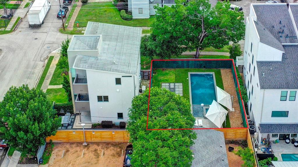 an aerial view of a house with swimming pool garden and patio