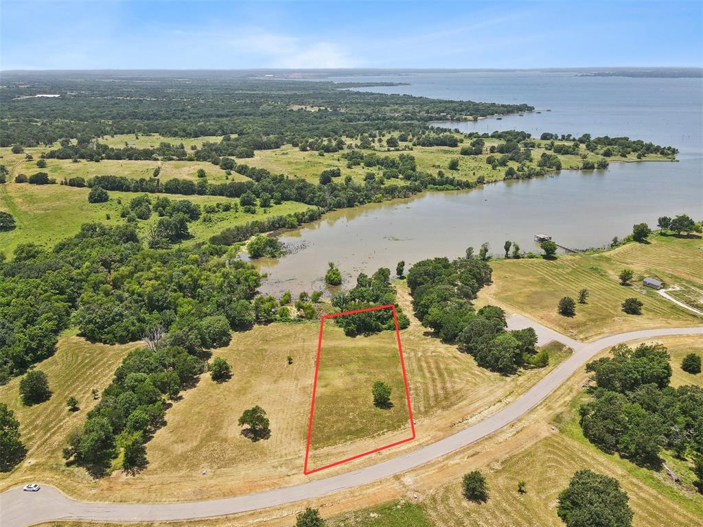 an aerial view of a house with a lake view