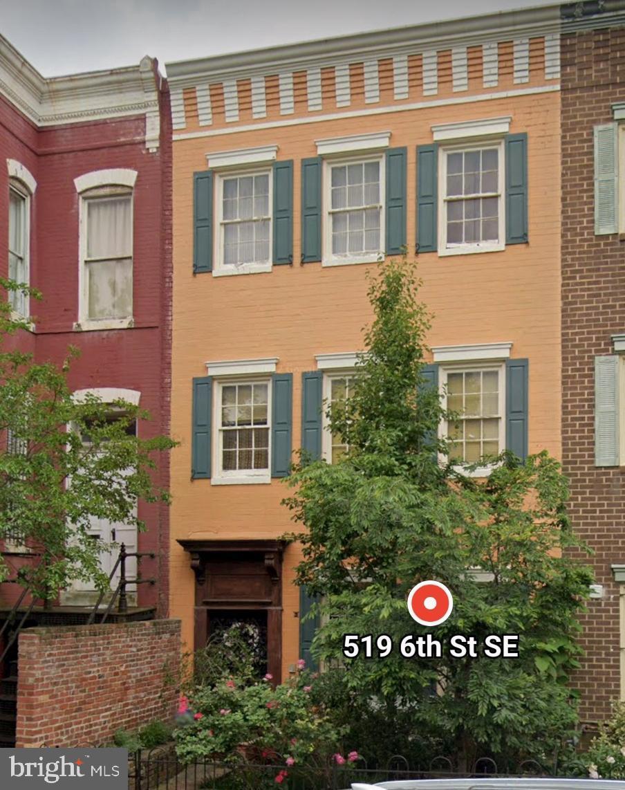 a view of a brick house with a yard