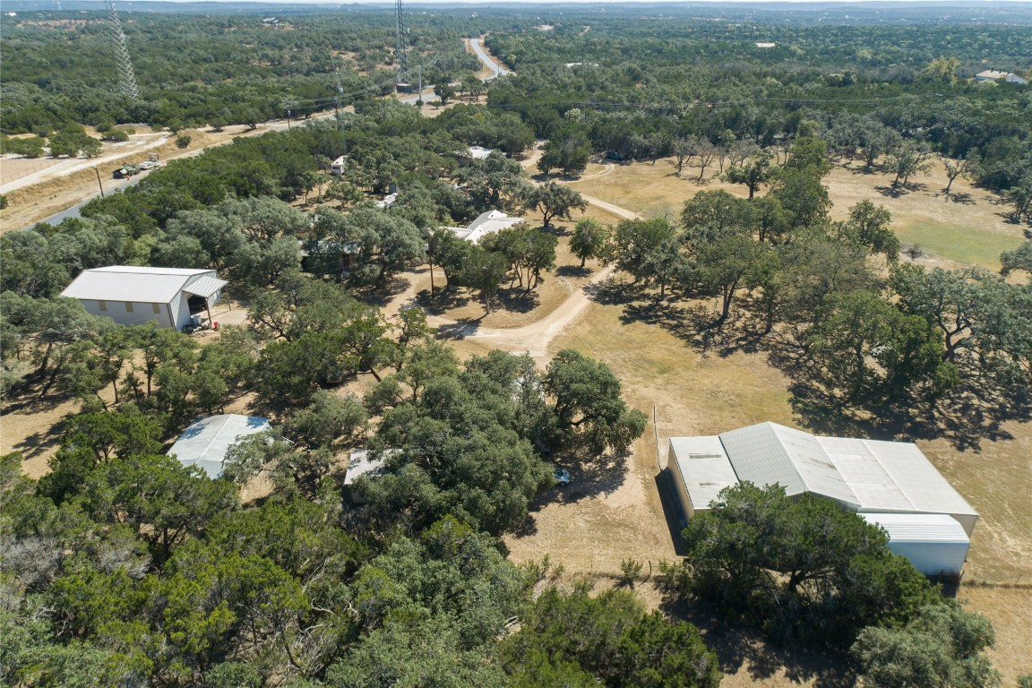 an aerial view of house with yard and mountain view in back