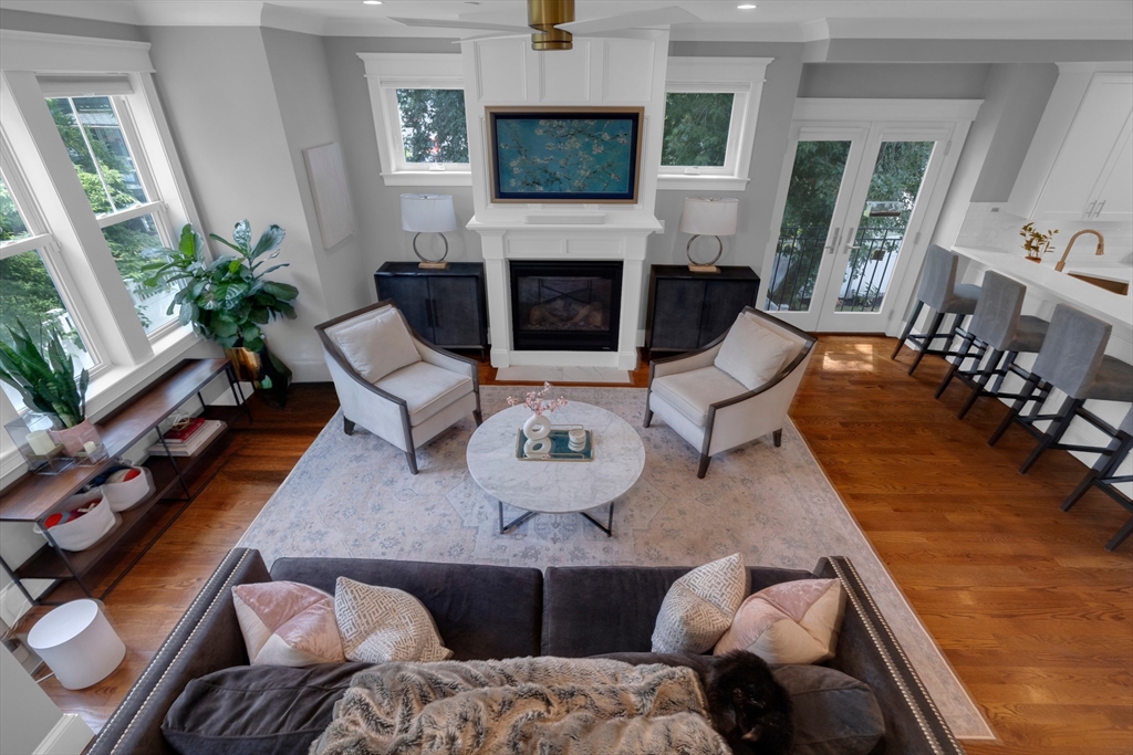 a living room with furniture large window and a fireplace