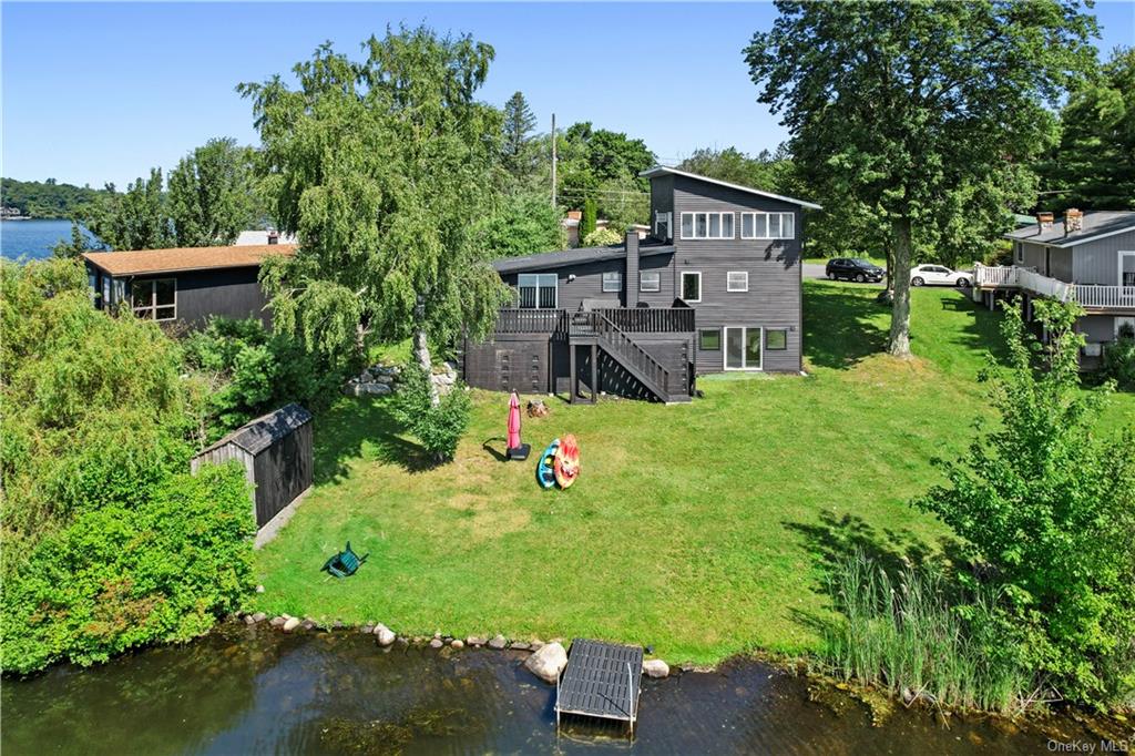 an aerial view of a house with swimming pool garden and patio